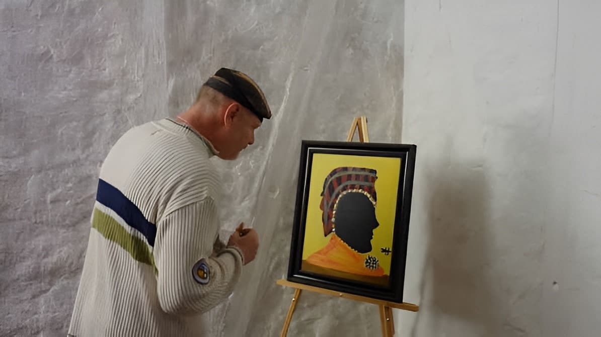 Joseph Sembrat at work conserving a painting on site