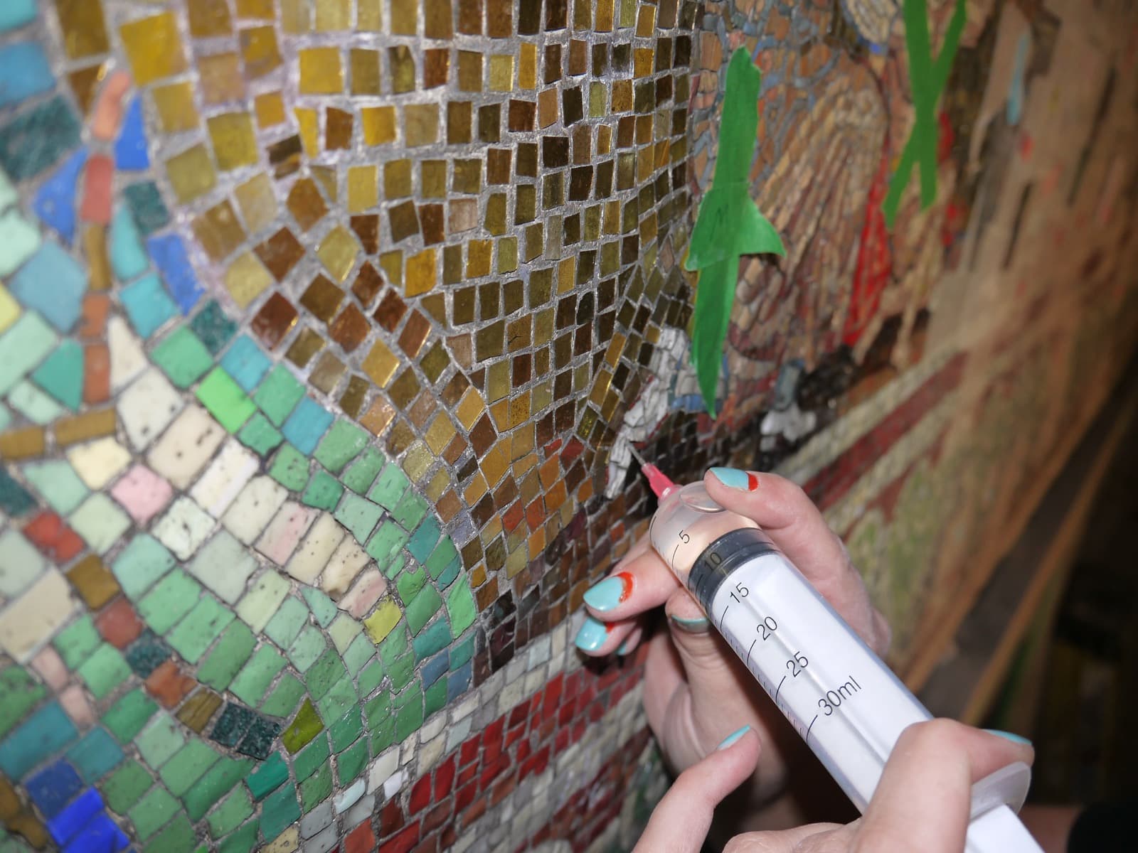 Conservators consolidating a historic mosaic ceiling on site